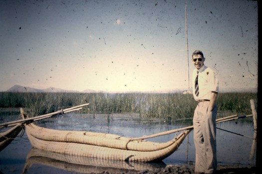 RAF pilot Ronald Walker standing beside a traditional reed boat in Egyptian wetlands during the early 1950s